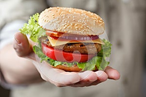 Fresh burger in the man's hand