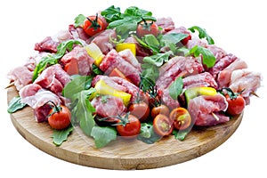 Fresh butcher cut meat assortment garnished on wooden board