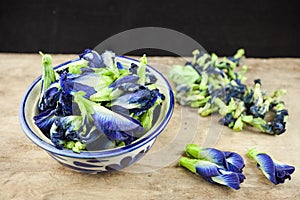 Fresh Butterfly pea flower or Clitoria ternatea on wooden plank