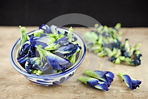 Fresh Butterfly pea flower or Clitoria ternatea on wooden plank