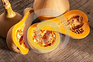 Fresh butternut squash on rustic wooden table