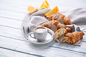 Fresh buttery croissants with coffee. Sweet morning breakfast concept