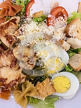 Fresh Caesar salad with chicken. Close up Caesar salad in home or dining room in healthy food concept
