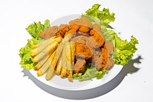 Fresh calamari with french fries in a plate. Healthy sea food squid fry, potato fries and lettuce meal on white background