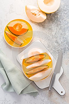 Fresh cantaloupe and lemon drop melon on cutting board - low calorie refreshment