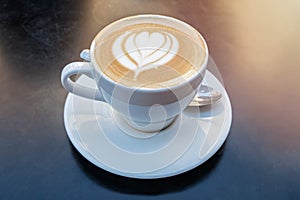 Fresh cappuchino or flat white coffee with latte art close-up