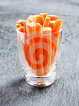 Fresh carrot batons in a glass container photo