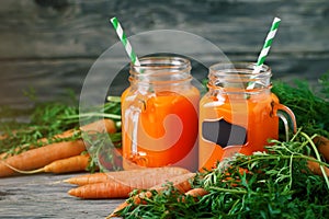 Fresh Carrot and carrot juice on Wooden Table in Garden. Vegetables Vitamins Keratin. Natural Organic Carrot lies on