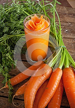 Fresh carrot juice glass with fresh organic carrots