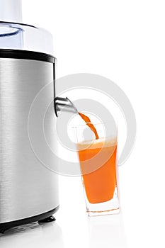 Fresh carrot juice with juicer.