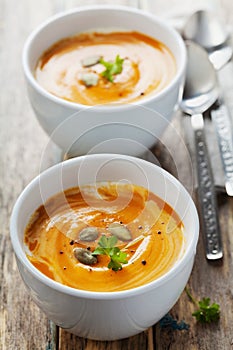 Fresh carrot soup in white bowl, dietary vegetable soup photo