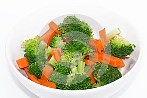 Fresh carrots and broccoli in a white bowl