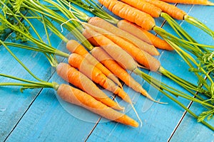 fresh carrots bunch on rustic wooden background photo