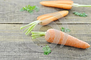 Fresh carrots and double cut on wooden rustic