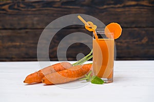 Fresh carrots with glass of juice