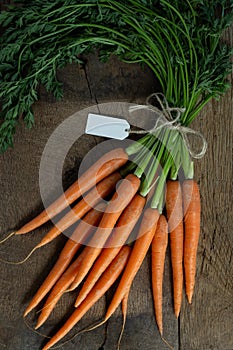 Fresh carrots on old wooden background