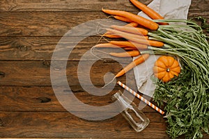 Fresh carrots on wooden background photo