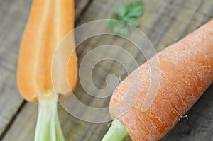 Fresh carrots with cut carrot on wooden rustic