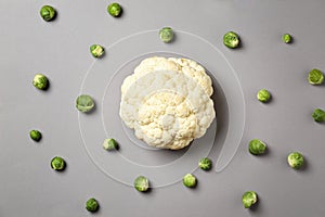 Fresh cauliflower and Brussels cabbage on grey background