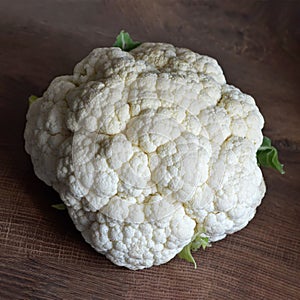 Fresh cauliflower on wooden background photo