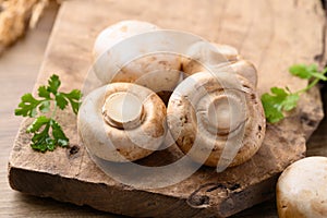 Fresh Champignon mushroom on wooden background