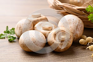 Fresh Champignon mushroom on wooden background