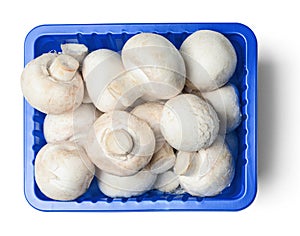 Fresh champignons in plastic packaging isolated on white background