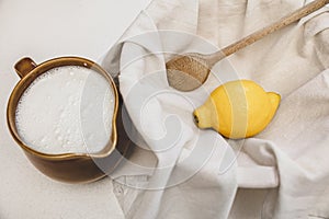 Fresh cheese making recipe ingredients, milk, lemon and a cotton cloth photo