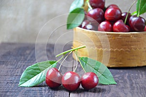 Fresh cherries in bowl on table