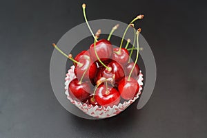 Fresh Cherry Fruit Health Vitamine in Cooking Bakery Cupcake Paper. Black Background Copy Space.