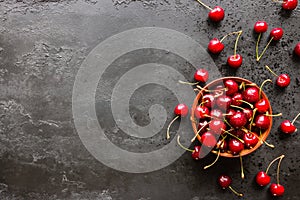 Fresh cherry in a plate and on a black background