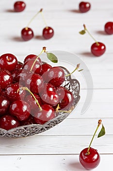 Fresh cherry on plate on wooden background. fresh ripe cherries