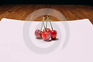 Fresh cherry on plate on wooden blue background. fresh ripe cherries. sweet cherries.