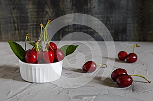 Fresh cherry on plate on wooden blue background. photo
