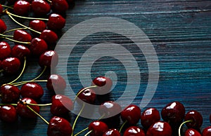 Fresh cherry on the table on wooden blue background. f photo