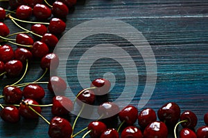 Fresh cherry on the table on wooden blue background. photo