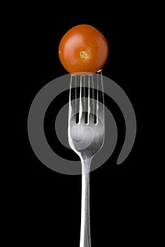 Fresh cherry tomato on a silver fork