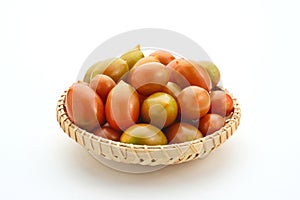 Fresh cherry tomatoes in the bamboo basket isolated on white background.