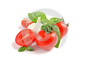 Fresh cherry tomatoes with basil and garlic isolated on white background