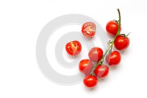 Fresh cherry tomatoes on a branch isolated on a white background. View from above