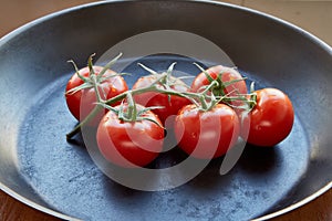 Fresh cherry tomatoes on dark background