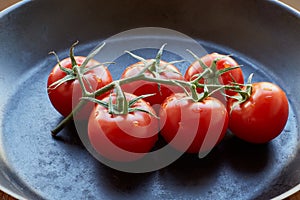 Fresh cherry tomatoes on dark background