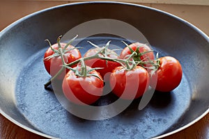 Fresh cherry tomatoes on dark background