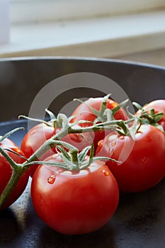 Fresh cherry tomatoes on dark background
