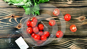 Fresh cherry tomatoes and green lettuce leaves