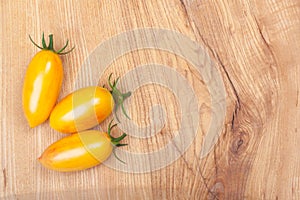 Fresh cherry tomatoes on a wooden chopping board