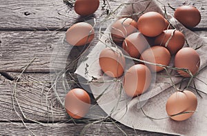 Fresh chicken brown eggs on rustic wood, organic farming concept