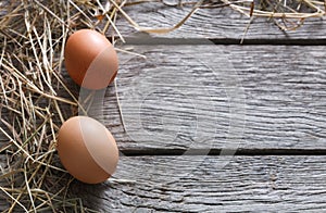 Fresh chicken brown eggs on rustic wood, organic farming concept background