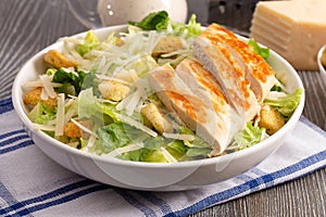 Fresh Chicken Caesar Salad on a Wooden Table