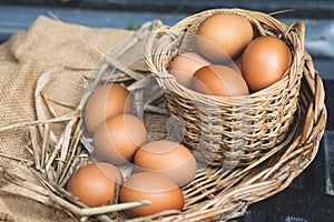 Fresh chicken eggs in a basket and carton box.